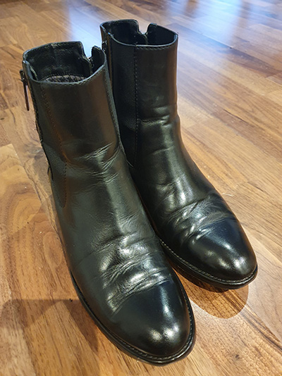 Pair of restored black Russell & Bromley womens boots after a shoeshine